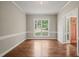 Inviting dining space featuring hardwood floors, neutral walls, and large window with a view at 1005 Barmkin Pl, Knightdale, NC 27545