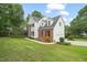 Charming two-story home with a brick and white siding exterior, a well-maintained lawn, and manicured landscaping at 1005 Barmkin Pl, Knightdale, NC 27545