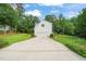 Exterior shot of the property showing the driveway, attached garage, and manicured landscaping at 1005 Barmkin Pl, Knightdale, NC 27545
