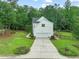 White two-story home with well-kept landscaping, an attached garage, and a long driveway at 1005 Barmkin Pl, Knightdale, NC 27545