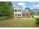 Charming two-story home featuring a manicured lawn, brick accents, and a classic design with dormer windows at 1005 Barmkin Pl, Knightdale, NC 27545
