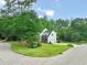 Beautiful white and brick two-story home on a corner lot surrounded by lush trees and landscaping at 1005 Barmkin Pl, Knightdale, NC 27545
