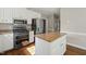 Bright kitchen features white cabinets, an island with granite countertops, and stainless steel appliances at 1005 Barmkin Pl, Knightdale, NC 27545