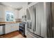 Kitchen with stainless steel refrigerator, granite countertops, white cabinets, and an oven at 1005 Barmkin Pl, Knightdale, NC 27545