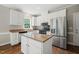 Charming kitchen with white cabinets, stainless steel appliances, and granite countertops at 1005 Barmkin Pl, Knightdale, NC 27545