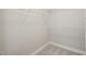 A walk-in closet features white wire shelving over gray carpeting at 1005 Barmkin Pl, Knightdale, NC 27545
