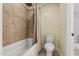 This bathroom showcases a shower-tub combo with neutral tiling, a toilet, and neutral wall coloring at 1009 Blue Larkspur Ave, Wake Forest, NC 27587
