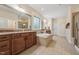 Spacious bathroom featuring a soaking tub, double vanity, walk-in shower and neutral tones at 1009 Blue Larkspur Ave, Wake Forest, NC 27587