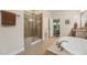 Well-lit bathroom boasting a glass enclosed shower and a soaking tub at 1009 Blue Larkspur Ave, Wake Forest, NC 27587
