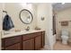 Well-appointed bathroom with a vanity, round mirror, and a shower-tub combo, offering functionality and style at 1009 Blue Larkspur Ave, Wake Forest, NC 27587