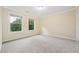 Bright bedroom with neutral carpet, two windows overlooking lush greenery at 1009 Blue Larkspur Ave, Wake Forest, NC 27587