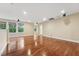 Bonus room features hardwood floors, neutral paint, and natural light provided by the multiple windows at 1009 Blue Larkspur Ave, Wake Forest, NC 27587