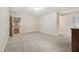 Spacious bonus room with neutral walls, carpet, and a glimpse of the hardwood floor in an adjoining room at 1009 Blue Larkspur Ave, Wake Forest, NC 27587