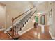 Inviting entryway with hardwood floors, a staircase with white railings, and a decorative front door at 1009 Blue Larkspur Ave, Wake Forest, NC 27587