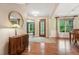Welcoming entryway with hardwood floors, elegant furnishings, and a decorative front door with sidelights at 1009 Blue Larkspur Ave, Wake Forest, NC 27587