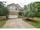 Charming two-story home with a well-maintained yard, a two-car garage, and a welcoming front porch at 1009 Blue Larkspur Ave, Wake Forest, NC 27587