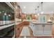 A kitchen with granite countertops, stainless appliances, a center island, and view of outdoor living through glass doors at 1009 Blue Larkspur Ave, Wake Forest, NC 27587