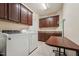 Well-organized laundry room with washer, dryer, storage cabinets, and a folding table at 1009 Blue Larkspur Ave, Wake Forest, NC 27587