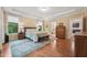 Serene main bedroom with large windows, hardwood floors, access to the bathroom and walk-in closet at 1009 Blue Larkspur Ave, Wake Forest, NC 27587