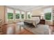 Serene main bedroom with large windows, hardwood floors, and a decorative rug at 1009 Blue Larkspur Ave, Wake Forest, NC 27587