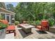 Cozy back patio with outdoor seating, fire pit, and access to screened-in porch at 1009 Blue Larkspur Ave, Wake Forest, NC 27587