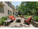 Backyard patio with comfortable seating, fire pit, and mature landscaping at 1009 Blue Larkspur Ave, Wake Forest, NC 27587