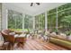 Cozy sunroom surrounded by lush greenery with natural light at 1009 Blue Larkspur Ave, Wake Forest, NC 27587