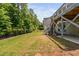 Expansive backyard features a well-maintained lawn, privacy fence, and a deck for outdoor enjoyment at 1030 Steinbeck Dr, Durham, NC 27703