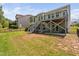 Exterior view shows grassy yard and a two-story deck at 1030 Steinbeck Dr, Durham, NC 27703
