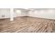 Large unfinished basement, with wood flooring, presents an adaptable space for recreation or storage at 1030 Steinbeck Dr, Durham, NC 27703