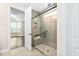Modern bathroom featuring a tiled shower with glass door and a bench at 1030 Steinbeck Dr, Durham, NC 27703