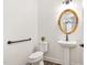 Half bathroom featuring a pedestal sink and a decorative mirror at 1030 Steinbeck Dr, Durham, NC 27703