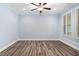 Calm bedroom features wood-look floors, neutral paint, shuttered windows and a ceiling fan at 1030 Steinbeck Dr, Durham, NC 27703