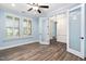 Serene bedroom offering wood-look floors, shuttered windows, and glass panel doors at 1030 Steinbeck Dr, Durham, NC 27703