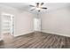 Bedroom with ceiling fan, wood flooring, and doors that lead to a closet and additional room at 1030 Steinbeck Dr, Durham, NC 27703