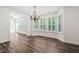 Elegant dining area showcasing wood floors, bright bay windows with shutters, and an open floor plan at 1030 Steinbeck Dr, Durham, NC 27703