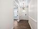 Bright entryway featuring wood floors, white trim, and an elegant chandelier at 1030 Steinbeck Dr, Durham, NC 27703
