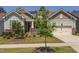 Charming home featuring a two-car garage, landscaped yard, and stone accents at 1030 Steinbeck Dr, Durham, NC 27703