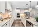 Modern kitchen with stainless steel appliances, granite countertops and chandelier lighting at 1030 Steinbeck Dr, Durham, NC 27703