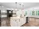 Open concept kitchen with granite island, stainless appliances, and seamless flow to living spaces at 1030 Steinbeck Dr, Durham, NC 27703