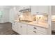 Gourmet kitchen with stainless steel appliances, stone backsplash, and white cabinets at 1030 Steinbeck Dr, Durham, NC 27703