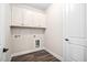 Laundry room with white cabinets and hardwood floors at 1030 Steinbeck Dr, Durham, NC 27703