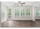 Inviting living room boasts wood floors, lots of natural light from shuttered windows, and a door to the deck at 1030 Steinbeck Dr, Durham, NC 27703