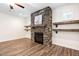 Inviting living room with a stone fireplace and rustic wooden shelving at 1030 Steinbeck Dr, Durham, NC 27703