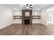 Living room featuring a stone fireplace with wooden shelving, lots of natural light at 1030 Steinbeck Dr, Durham, NC 27703
