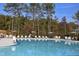 A pristine community pool with ample seating and umbrellas, perfect for relaxation and recreation at 1030 Steinbeck Dr, Durham, NC 27703