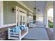 Charming porch swings with plush pillows line the covered walkway of the clubhouse at 1030 Steinbeck Dr, Durham, NC 27703