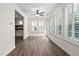 Cozy sunroom features wood flooring, shuttered windows for natural light, and a ceiling fan at 1030 Steinbeck Dr, Durham, NC 27703