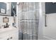 Cozy bathroom with a decorative shower curtain and a nautical themed vanity at 110 E Church St, Creedmoor, NC 27522
