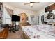 Spacious bedroom featuring a ceiling fan, large armoire, and comfortable bed with floral patterned comforter at 110 E Church St, Creedmoor, NC 27522